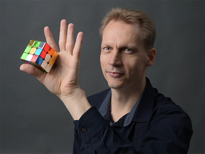 Zoltan Matanyi, an IT strategist with a passion for puzzles, holds a Rubik's cube in his hand.